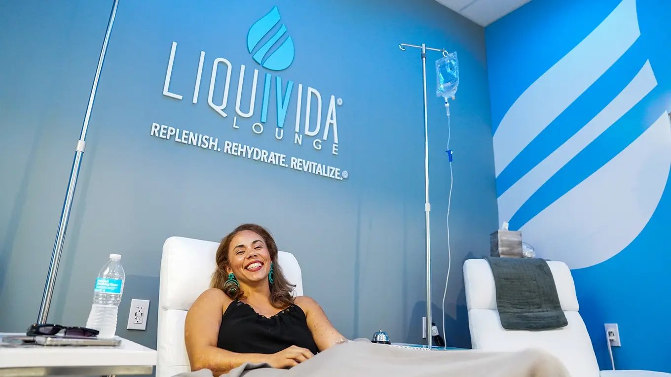 Happy female Liquivida client getting IV drips