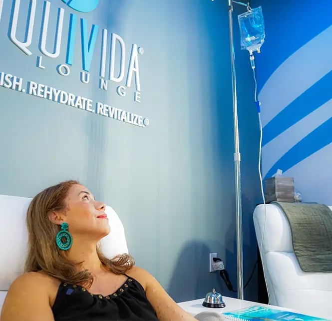 Liquivida female client looks at an IV drip