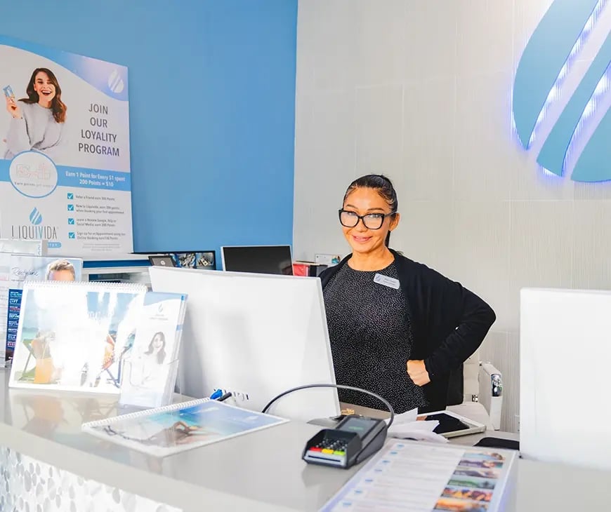 Receptionist at Liquivida Wellness Center working on a tour reservation for the Enlightened Living Program