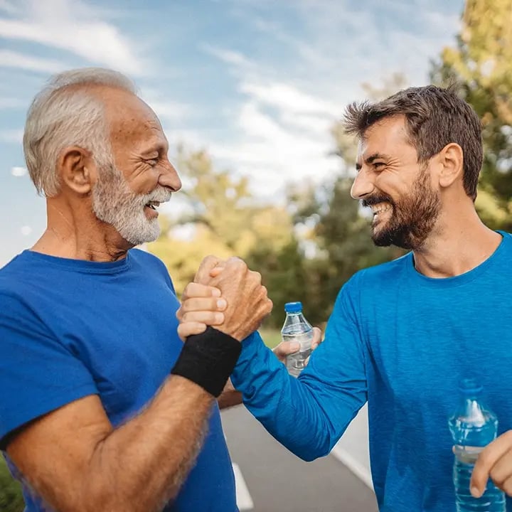 Father and son shake hands as they exercise before their Hormone Replacement check up at Liquivida Wellness Center
