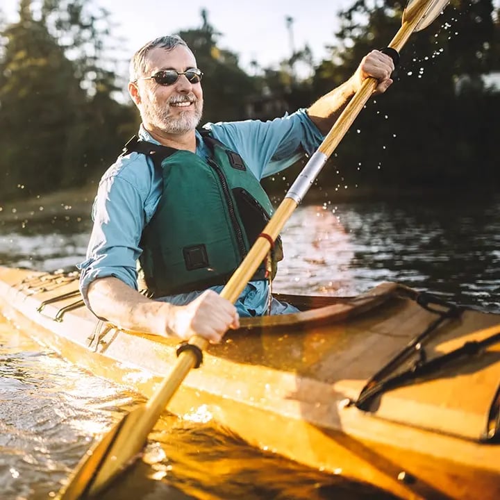 Man full of testosterone is kayaking after visiting Liquivida Wellness Center