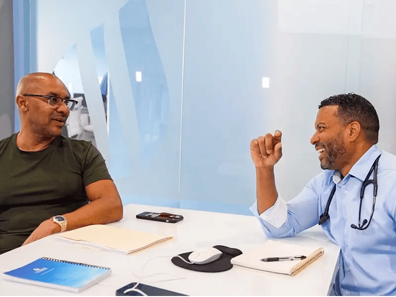 Dr. Christopher Davis discusses a lab test with Corey Jacobs at Liquivida Wellness Center
