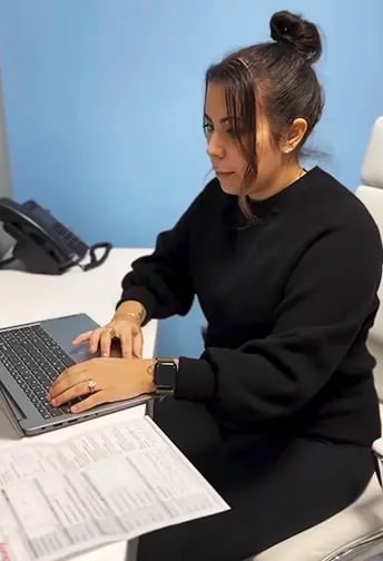 Female Wellness Coordinator reviewing lab results of a patient at Liquivida Middletown