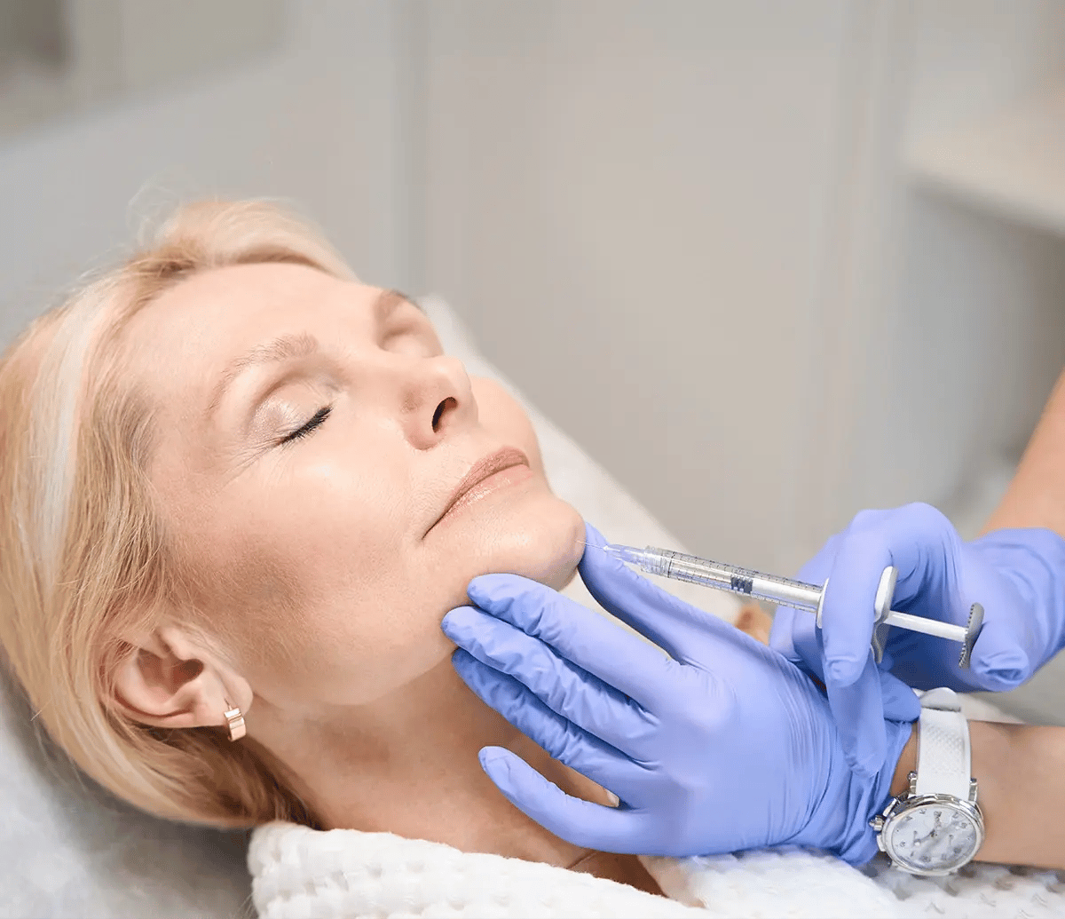 White mature women gets a Botox shot on her chin at Liquivida