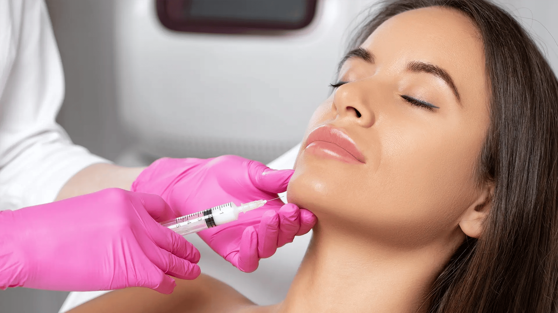 Black woman receives Kybella injection on her face at Liquivida Wellness Center