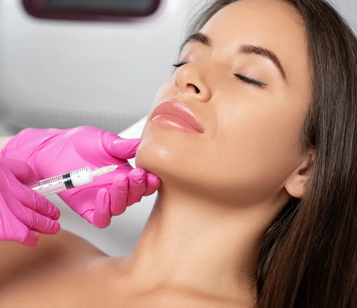 Black woman receives Kybella injection on her face at Liquivida
