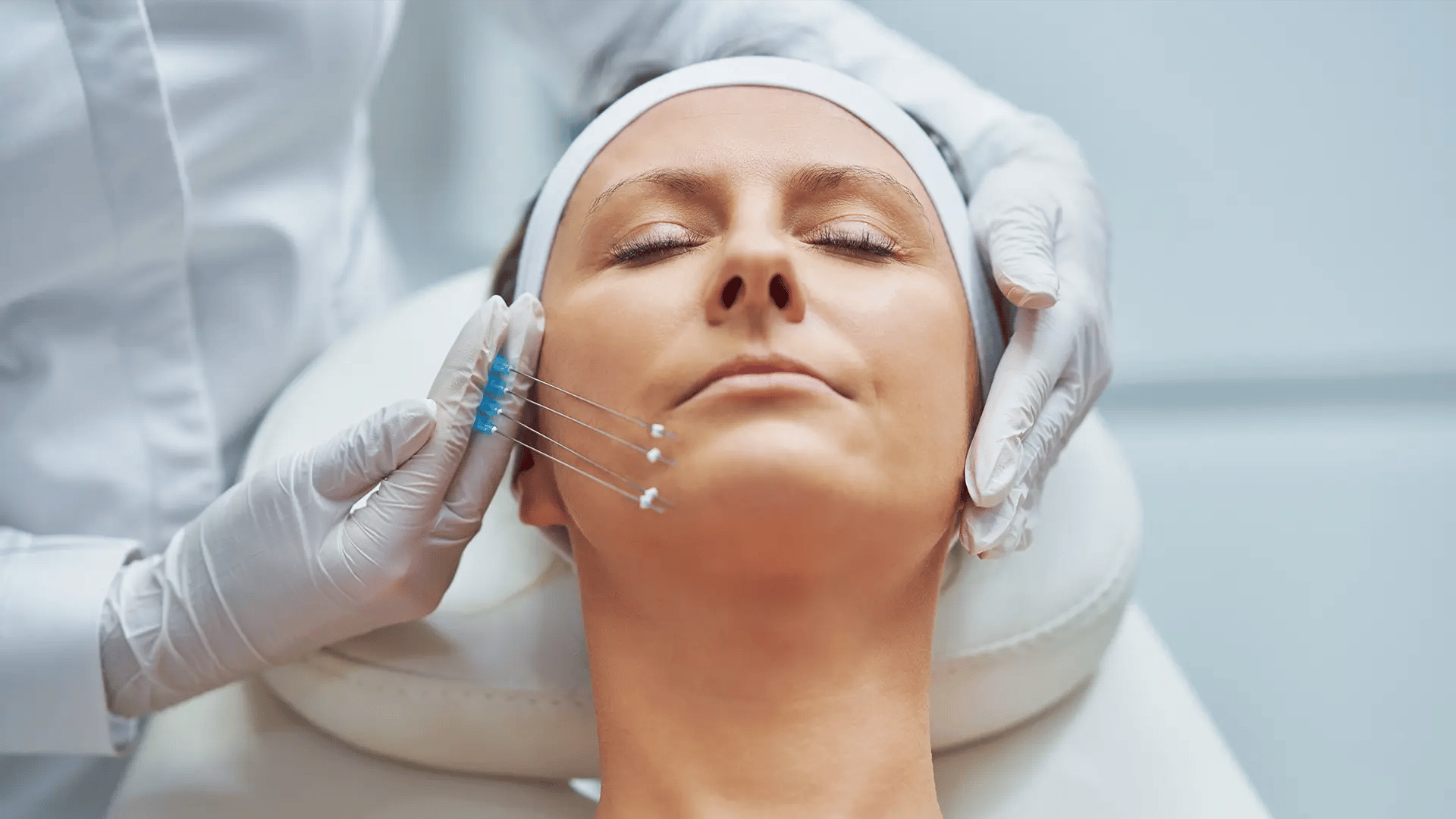 Practitioner measuring PDO Threads next to the face of a woman at Liquivida Wellness Center