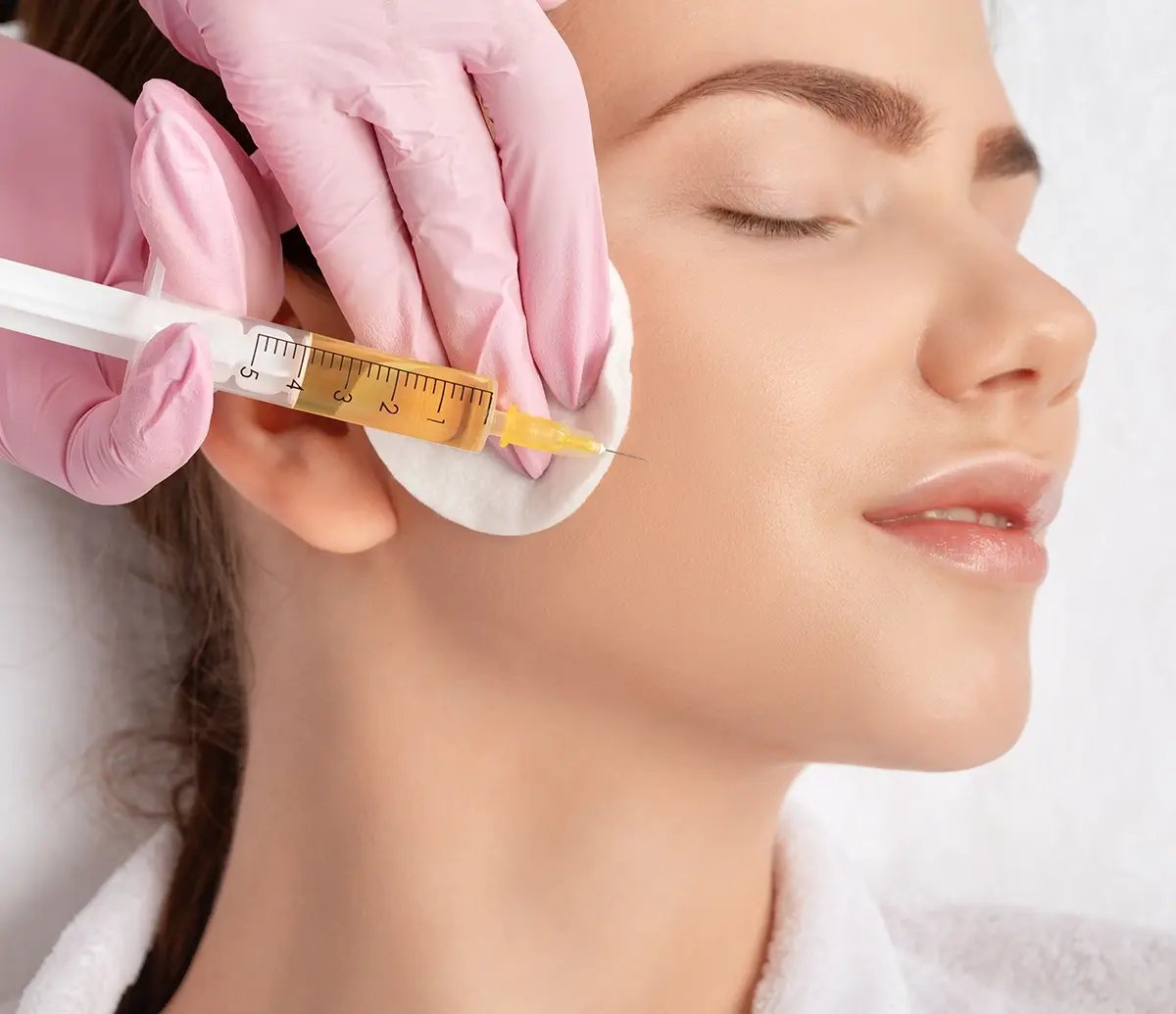 Woman getting a PRP facial on her right cheek at Liquivida