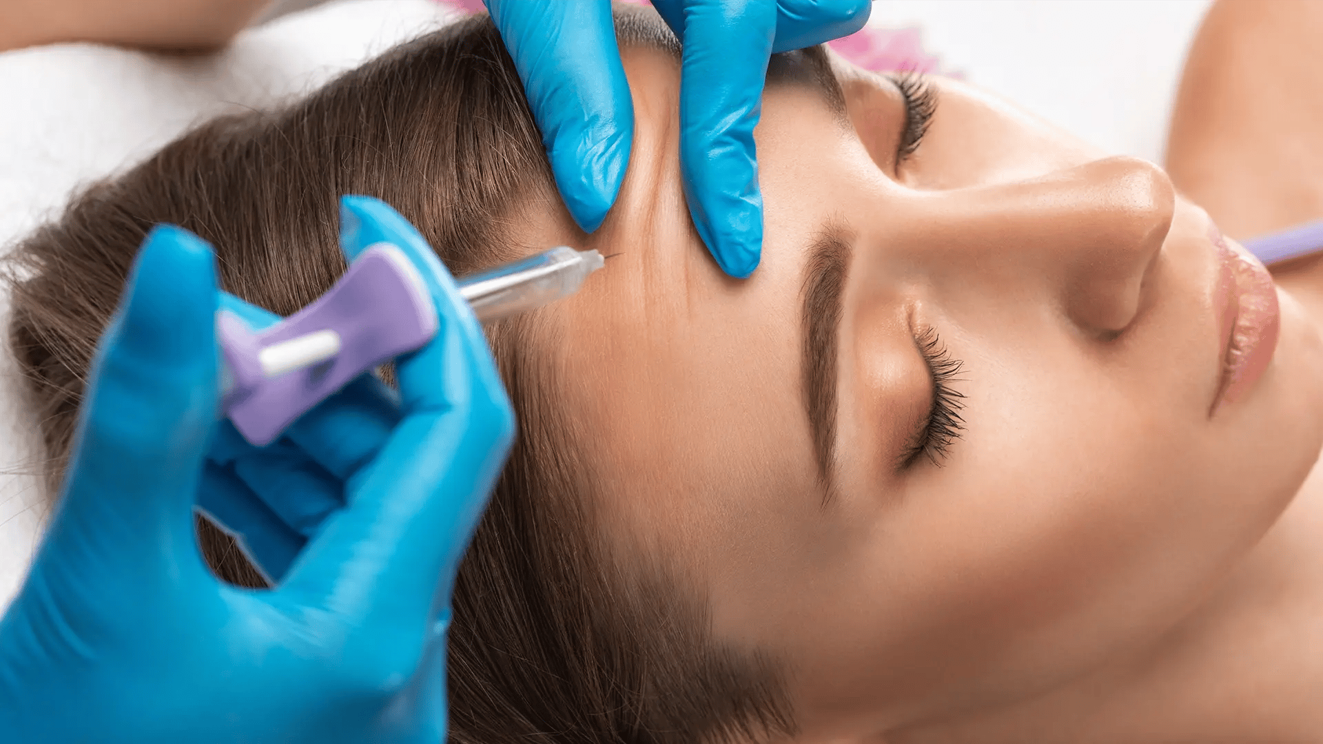 Woman gets a Revanesse injection on her forehead at Liquivida Wellness Center