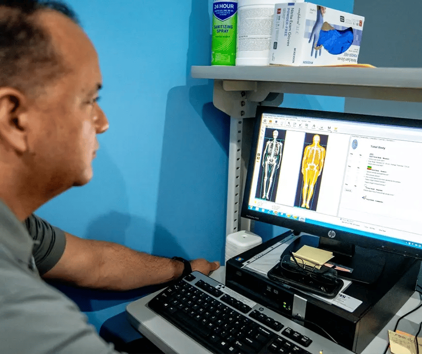 Technician analysing the results of a DEXA scan at Liquivida Wellness Center