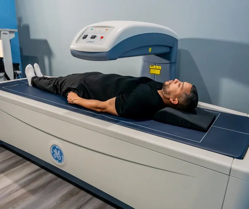 Male laying down while a DEXA Scan is completed at Liquivida Wellness Center