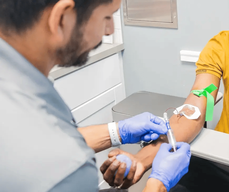 Practitioner taking a blood sample for lab testing included in Enlightened Living Program at Liquivida Wellness Center