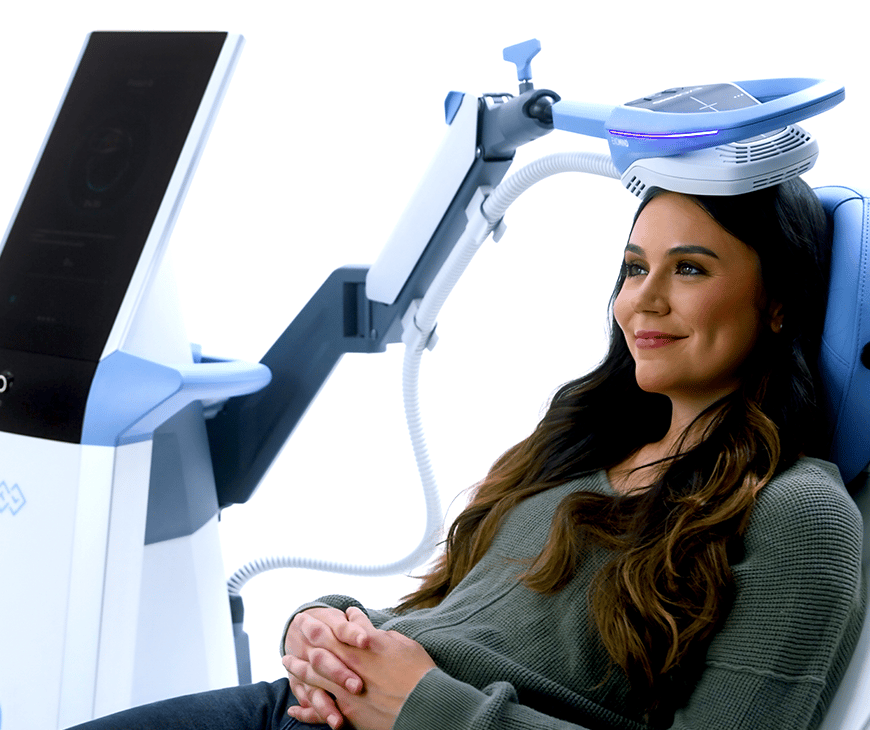 A woman smiling while getting Exomind therapy at Liquivida