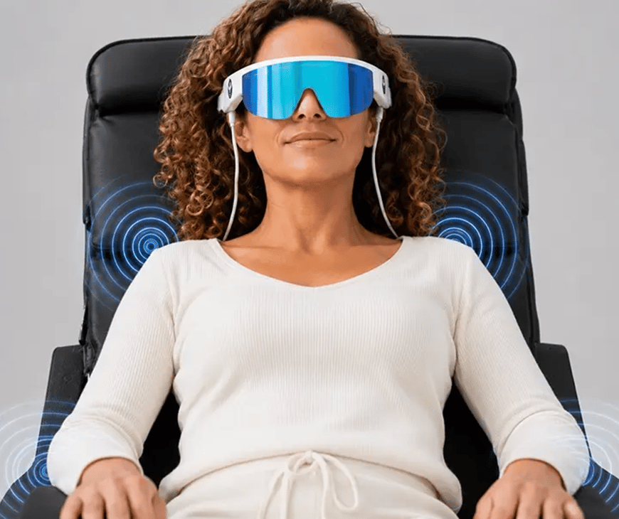 Woman wearing PSiO glasses while sitting in a PSiO chair at Liquivida