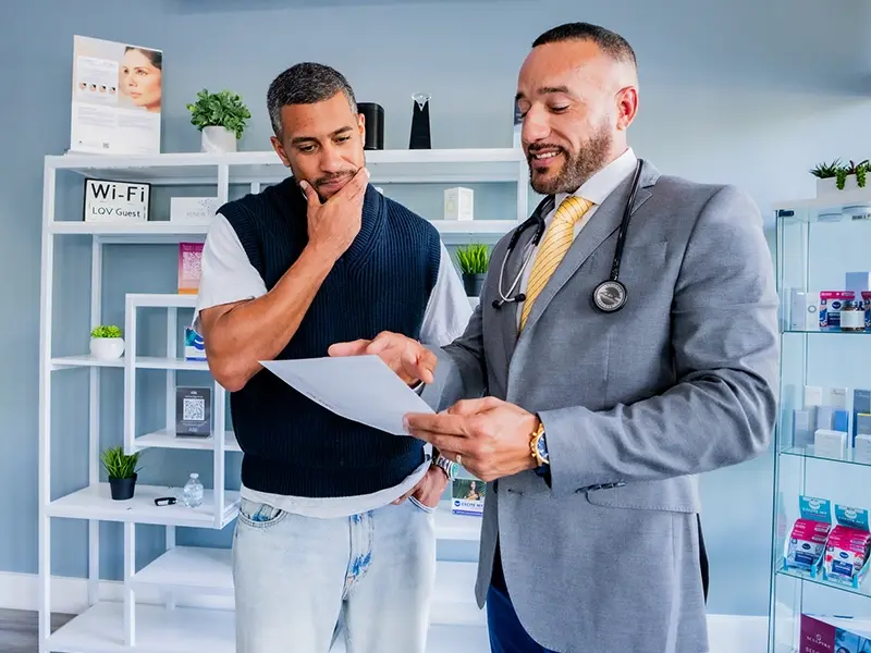 Male doctor explaining lab test results to a male patient at Liquivida Wellington